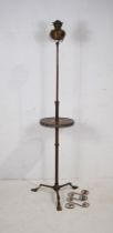 An antique adjustable brass standard oil lamp, with integral table, raised on tripod base - some