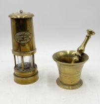 A brass miner's lamp named to Ferndale Coal along with a brass pestle and mortar