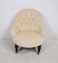 A Victorian upholstered nursing chair, with button-back detailing, raised on ebonised turned legs