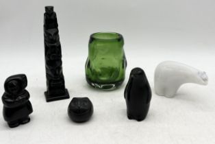 A collection of resin figures and totems from Columbia Coast Artware, Canada, along with a