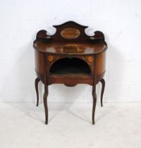 An antique French inlaid mahogany bow-fronted dressing table of small proportions, with mirrored