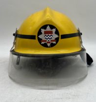 A collection of London Fire Service memorabilia including a helmet, a fireman's belt, a framed