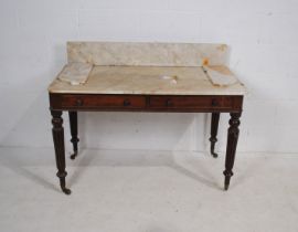 A Victorian mahogany marble topped side table, with two drawers, raised on tapering reeded legs -