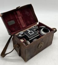 A Kochman Reflex Korelle II in leather case fitted with Carl Zeiss Jena lens along with additional