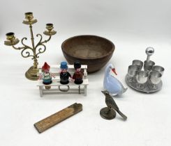 An assortment of items including brass candle stick, novelty bottle stopper set, brass bird etc.