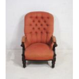 A Victorian mahogany framed upholstered armchair, with button-back detailing and carved decoration