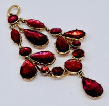A 9ct rose gold pendant set with garnet coloured stones