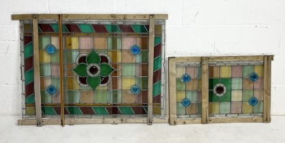 Two stained glass panels the large with central floral motif