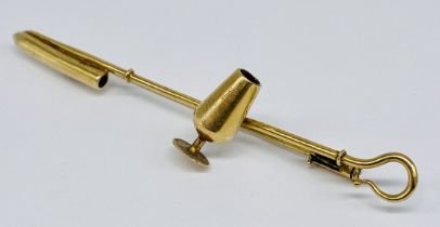 An unmarked gold (tests at 14ct +) in the form of a crook and wine goblet, length approx. 6.5cm,