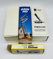 A collection of three boxed die-cast cranes including Grove Worldwide Carrier-Mounted Hydraulic