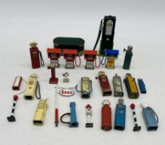 A collection of die-cast petrol pumps including Esso, Shell etc, also with a few road signs