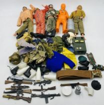 A collection of vintage Action Man figures, along with accessories including clothing, weapons,