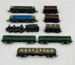 A collection of unboxed OO gauge model railway locomotives and carriages including two Lima diesel