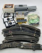 A collection of model railway OO gauge accessories and scenery including platforms, controllers,