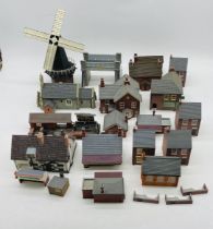 A collection of unboxed Hornby Skaledale OO gauge buildings including stations, bridge, church, pub,