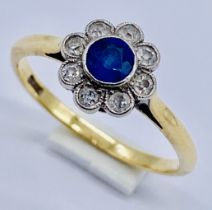 An 18ct gold ring set with a sapphire and diamond cluster, size P