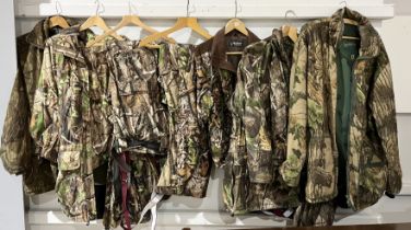 A collection of Deerhunter clothing including a number of jackets and trousers all in camouflage