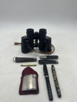 An assortment of vintage items including a Ronson lighter, some Carl Zeiss Jenoptem 8 x 30w