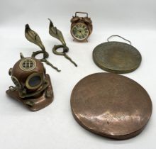 A collection of items including brass divers helmet, coat hooks in the form of cobras, Eastern gongs