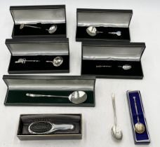 A collection of cased hallmarked silver spoons, hairbrush etc.