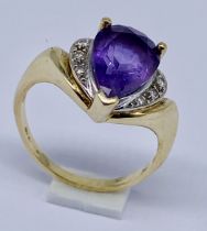 A 9ct gold ring set with a teardrop shaped amethyst and diamonds, size O