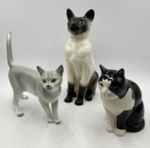 Three ceramic cat figures including larger Beswick Siamese, grey Czech made cat etc.