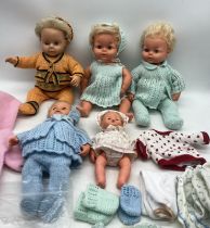 Four vintage dolls including Palitoy along with an assortment of clothing