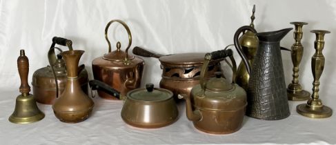 A collection of brass and copper including kettles, pair of candlesticks, antique saucepan with