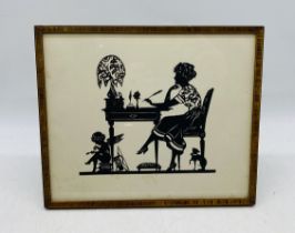 An early 20th century framed cut-out silhouette - overall size 25cm x 30cm
