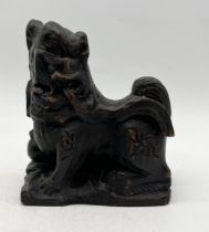 An Eastern carved wooden temple dog