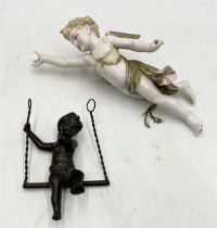 A porcelain wall hanging cupid in the Meissen style (repair work as shown) along with a bronze