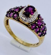 A garnet and diamond dress ring set in 9ct gold, size O 1/2