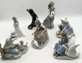 A collection of various Nao figurines along with a USSR otter