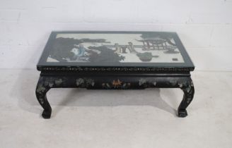 An Oriental lacquered rectangular coffee table, decorated with traditional scenes with character