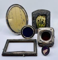 A collection of hallmarked silver photo frames along with a silver watch case- some A/F