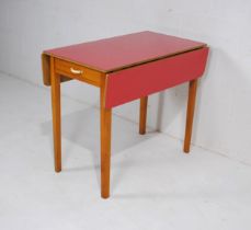 A retro 1960s drop-leaf dining table, with single drawer