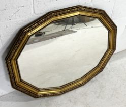 A large gilt framed mirror with shaped frame