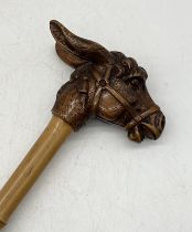 A Victorian parasol with carved handle in the form of a donkey