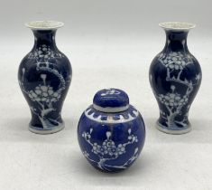 A small pair of Chinese prunus vases (13cm height) along with a small ginger jar in the same pattern