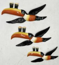 A graduated set of three Carlton Ware Guinness flying toucans, repair to the wing of largest