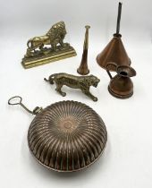 A collection of brass and copper items including brass tiger model, funnel, hot water bottle, lion