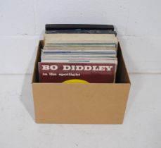 A collection of 12" vinyl records consisting of mostly 50's rock and roll and related, including