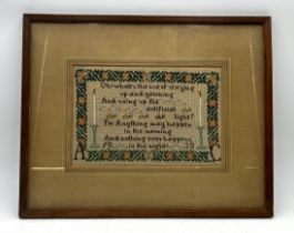 A framed needlework sampler dated 1939. 35cm x 44cm