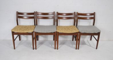 A set of four mid century dining chairs, with upholstered seats raised on tapering legs