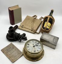 A collection of assorted items including war issue map case, ships clock, dominoes, Mrs Beeton's