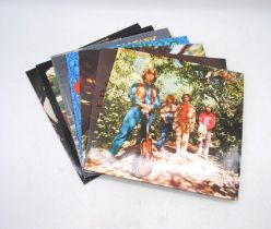A collection of seven 12" vinyl record albums by Creedence Clearwater Revival, including 'Willy &
