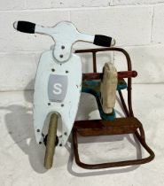 A weathered vintage child's rocker along with a handmade scoot-along in the form of a scooter.