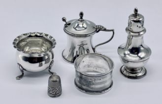 A small collection of hallmarked silver items including pepperette, mustard etc.
