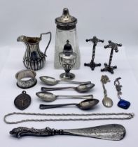 A collection of hallmarked silver including a cream jug, pepperette, knife rests, jewellery etc/