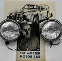 Two large vintage Cibie car spotlights along with a copy of "The Modern Motor Car" by Shell-Mex